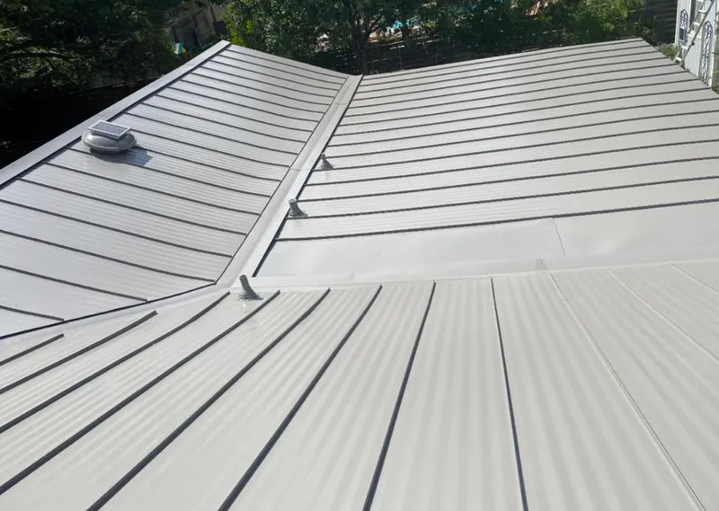 Solar attic fan installed on a metal roof for Roof Ventilation in Country Club